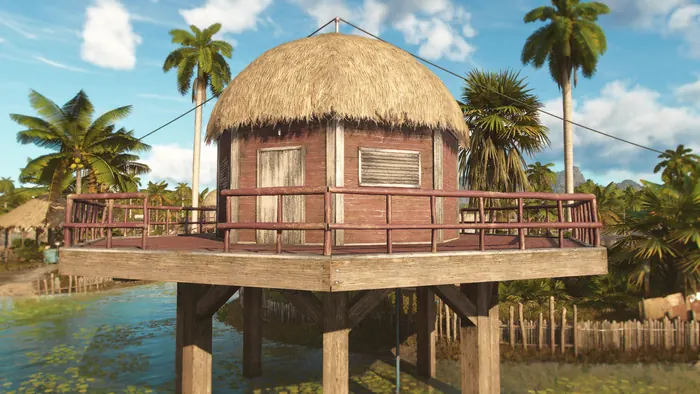 Thatched stilt cabana over turquoise water with palm trees